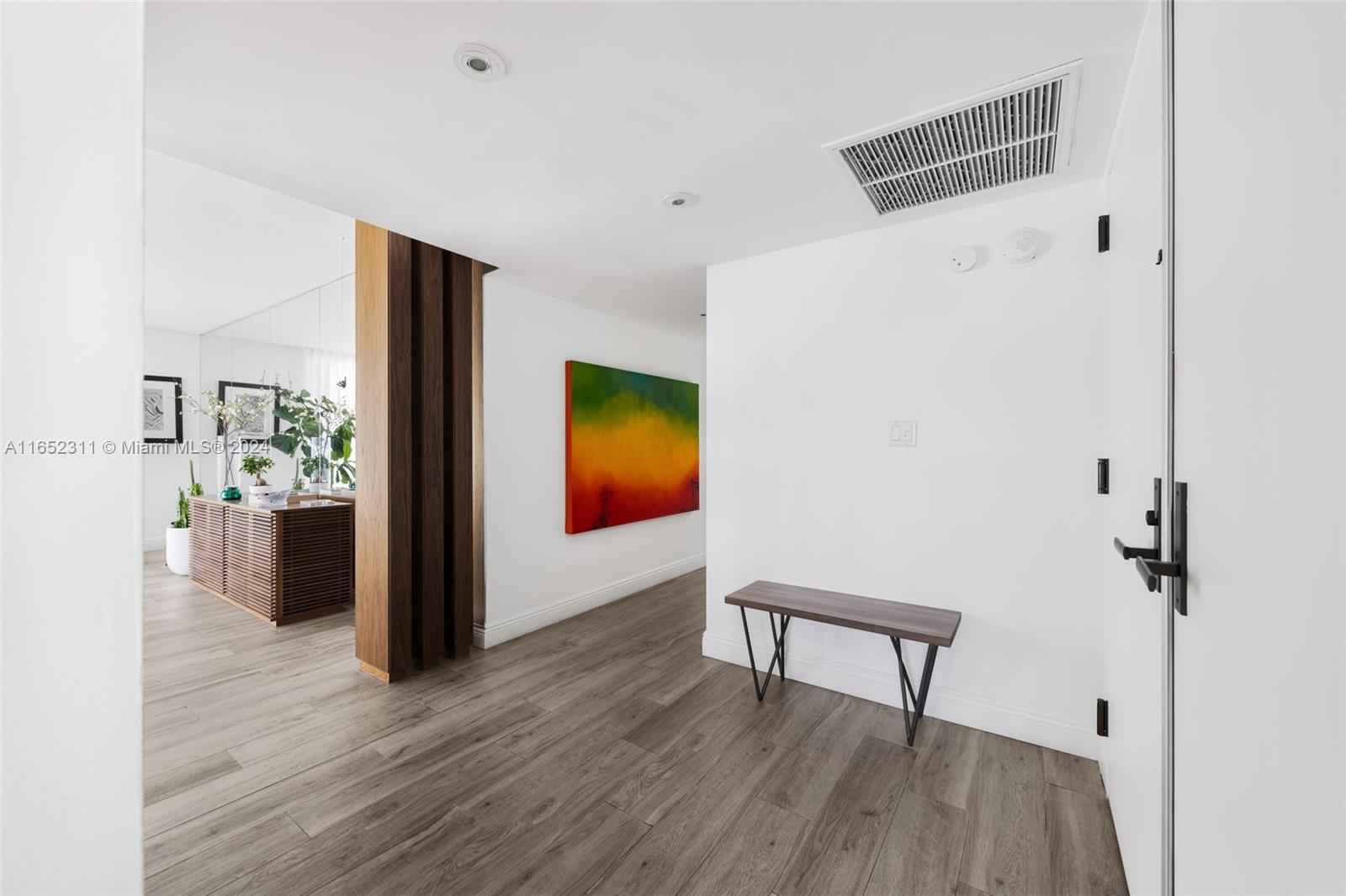 2 Grove Isle Drive, Unit B402 Miami, FL 33133 - Photo 3 of 35 a view of a room with wooden floor cabinet and windows