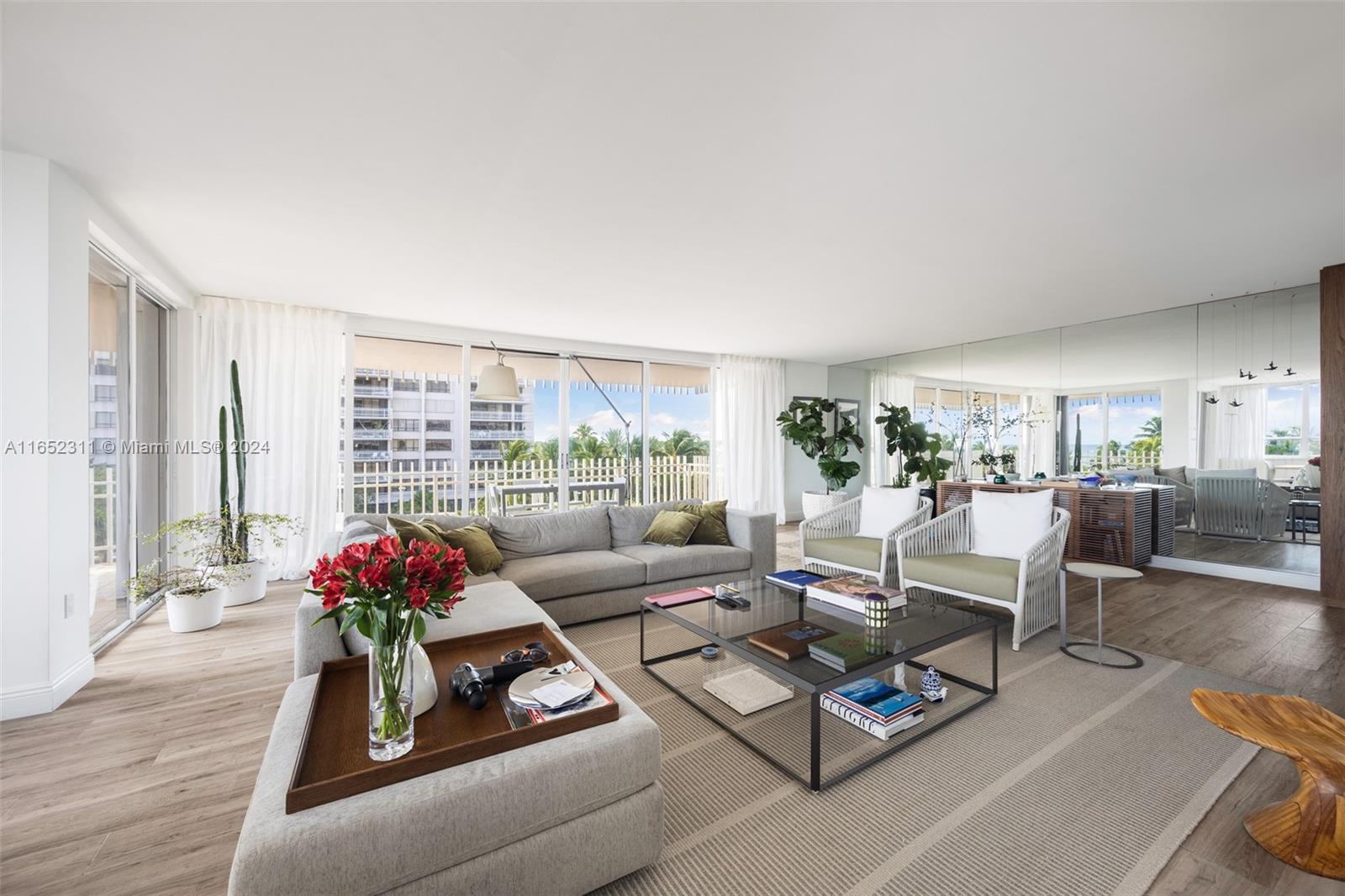 2 Grove Isle Drive, Unit B402 Miami, FL 33133 - Photo 5 of 35 a living room with furniture and a large window