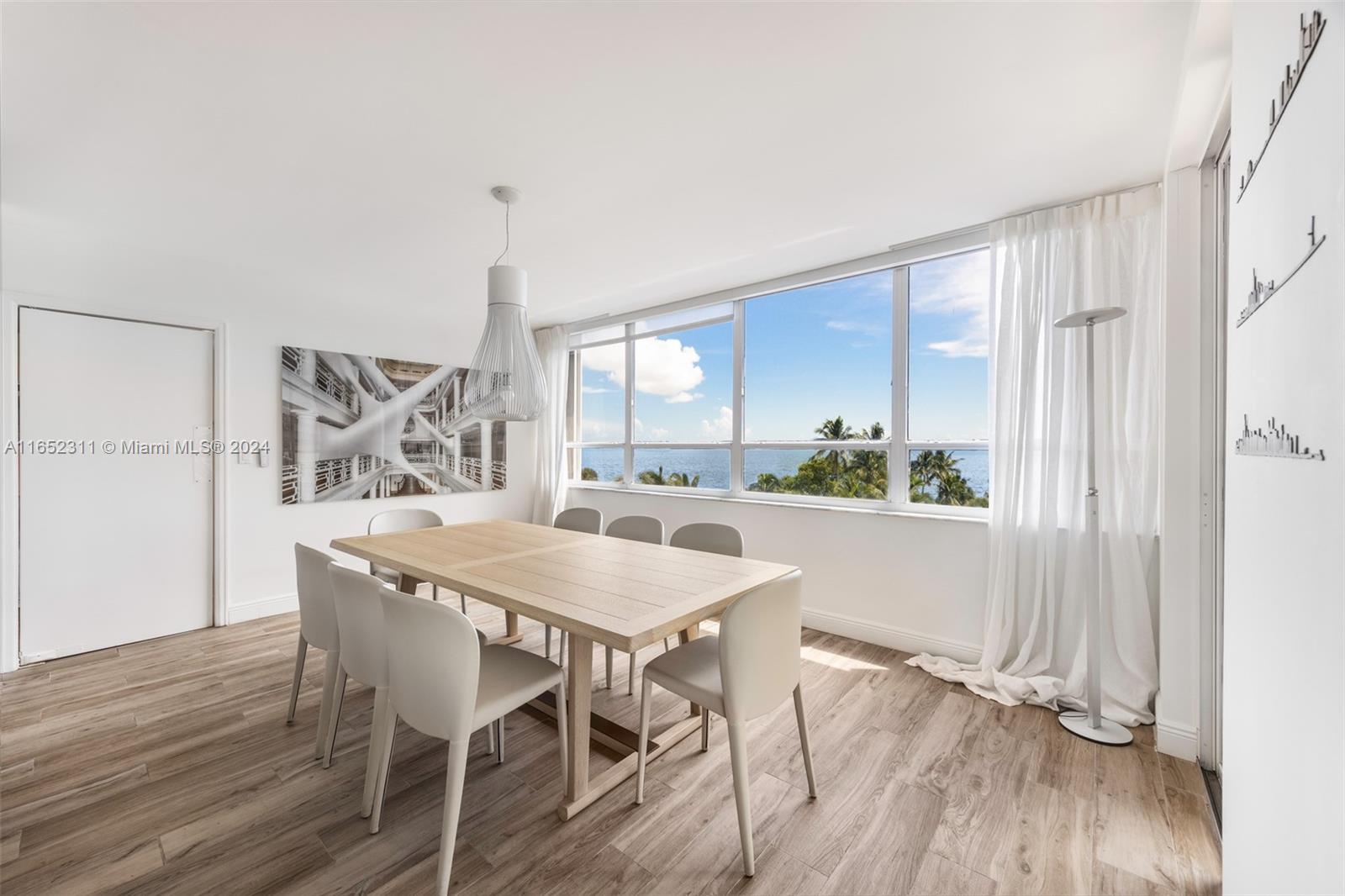 2 Grove Isle Drive, Unit B402 Miami, FL 33133 - Photo 7 of 35 a dining room with furniture window wooden floor