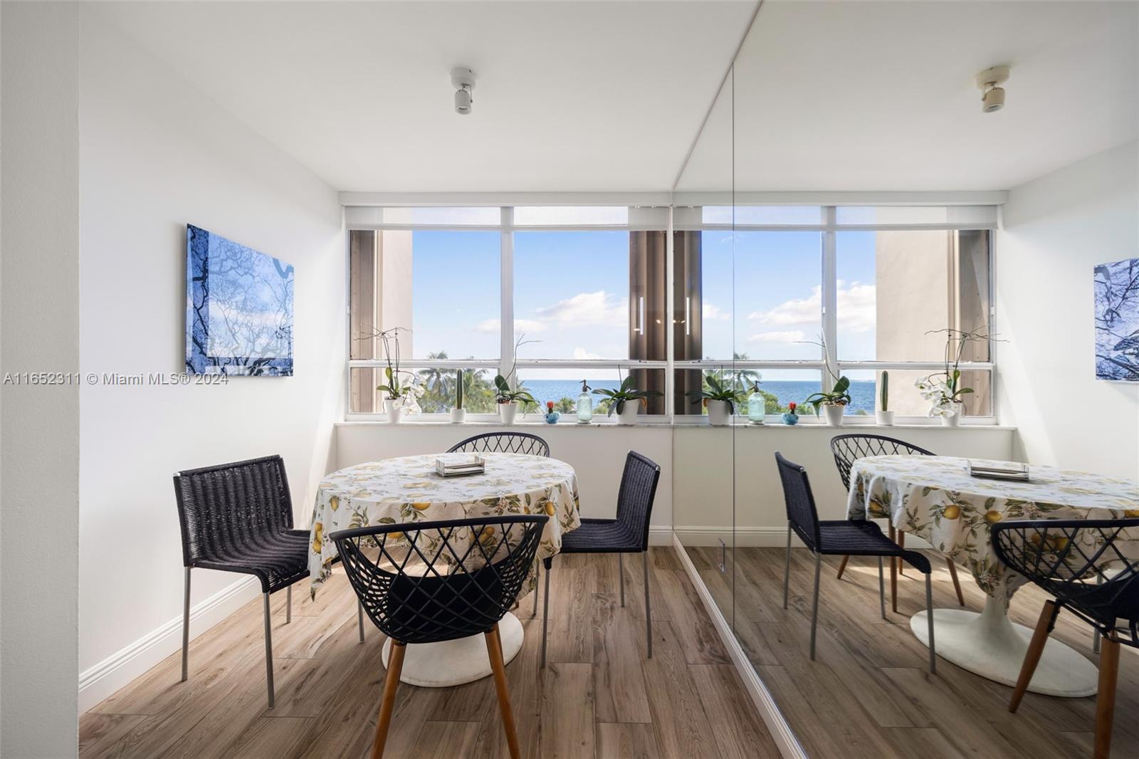2 Grove Isle Drive, Unit B402 Miami, FL 33133 - Photo 8 of 35 a view of a dining room with furniture and wooden floor