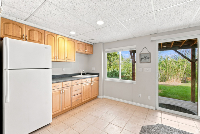 11882 Pond Ridge Drive Draper, UT 84020 - Photo 39 of 49 Kitchenette featuring a full-size refrigerator, wood cabinetry, and a ceramic tile floor