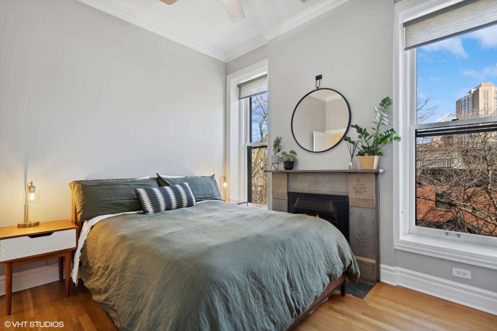 207 West St Paul Avenue, Unit 3W Chicago, IL 60614 - Photo 11 of 15 a bed sitting in a bedroom next to a window with a fireplace