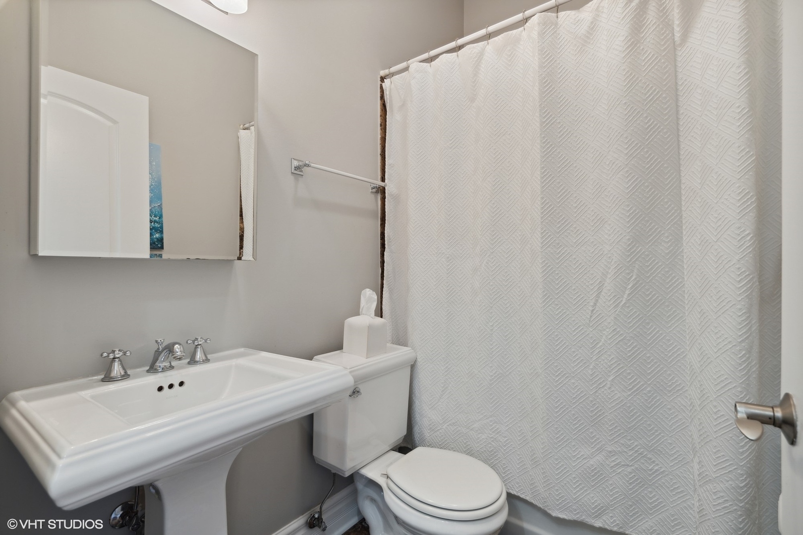 207 West St Paul Avenue, Unit 3W Chicago, IL 60614 - Photo 13 of 15 a bathroom with a sink a toilet and shower curtain