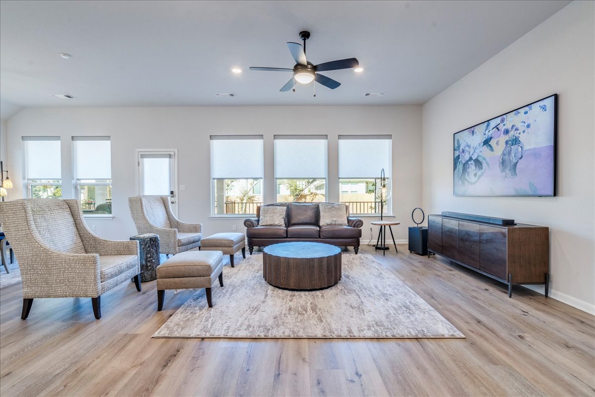 200 Christi Court Kyle, TX 78640 - Photo 6 of 40 Living room with light wood finished floors and ceiling fan