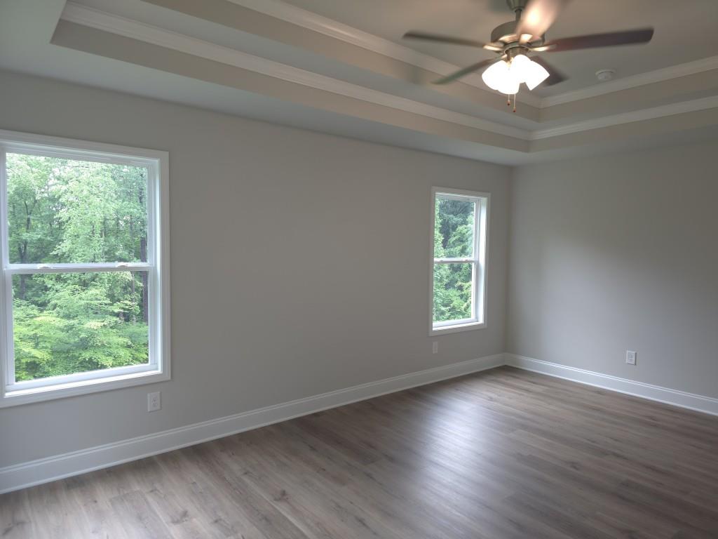 4240 Cavalier Way Duluth, GA 30097 - Photo 25 of 46 a view of an empty room with wooden floor and a window