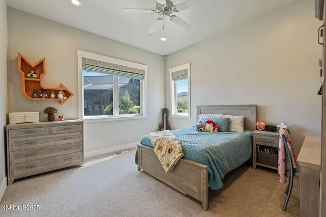 a bathroom with a toilet a sink a mirror a vanity and shower