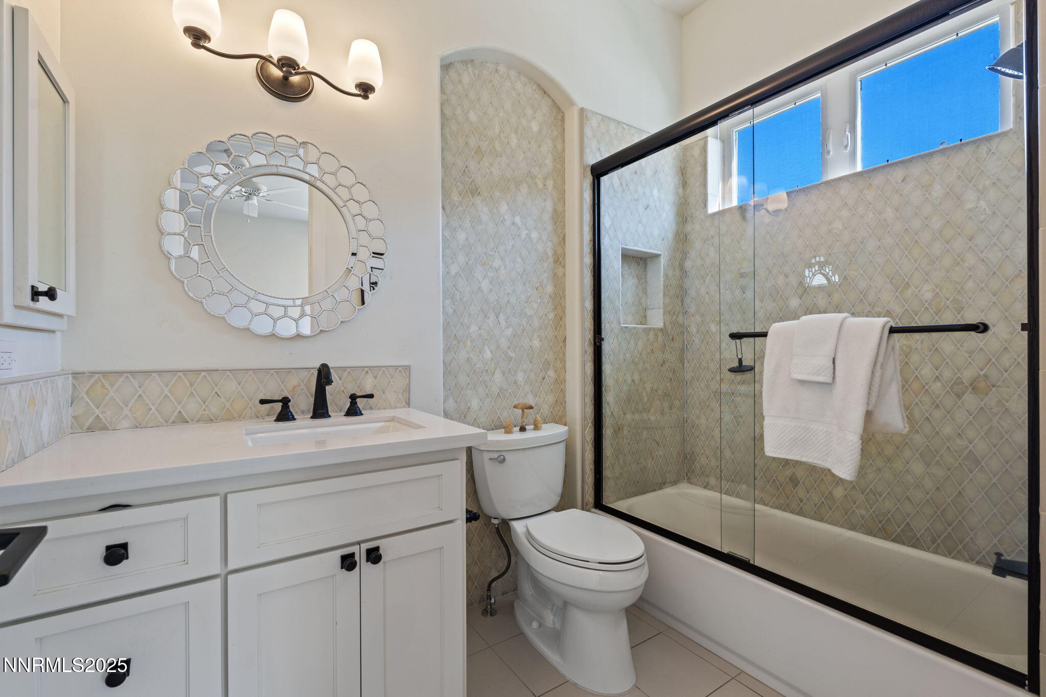 1020 North Cantlon Lane Reno, NV 89521 - Photo 18 of 28 a bathroom with a toilet a sink a mirror a vanity and shower