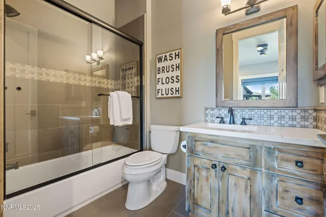 a spacious bedroom with a bed and a chandelier
