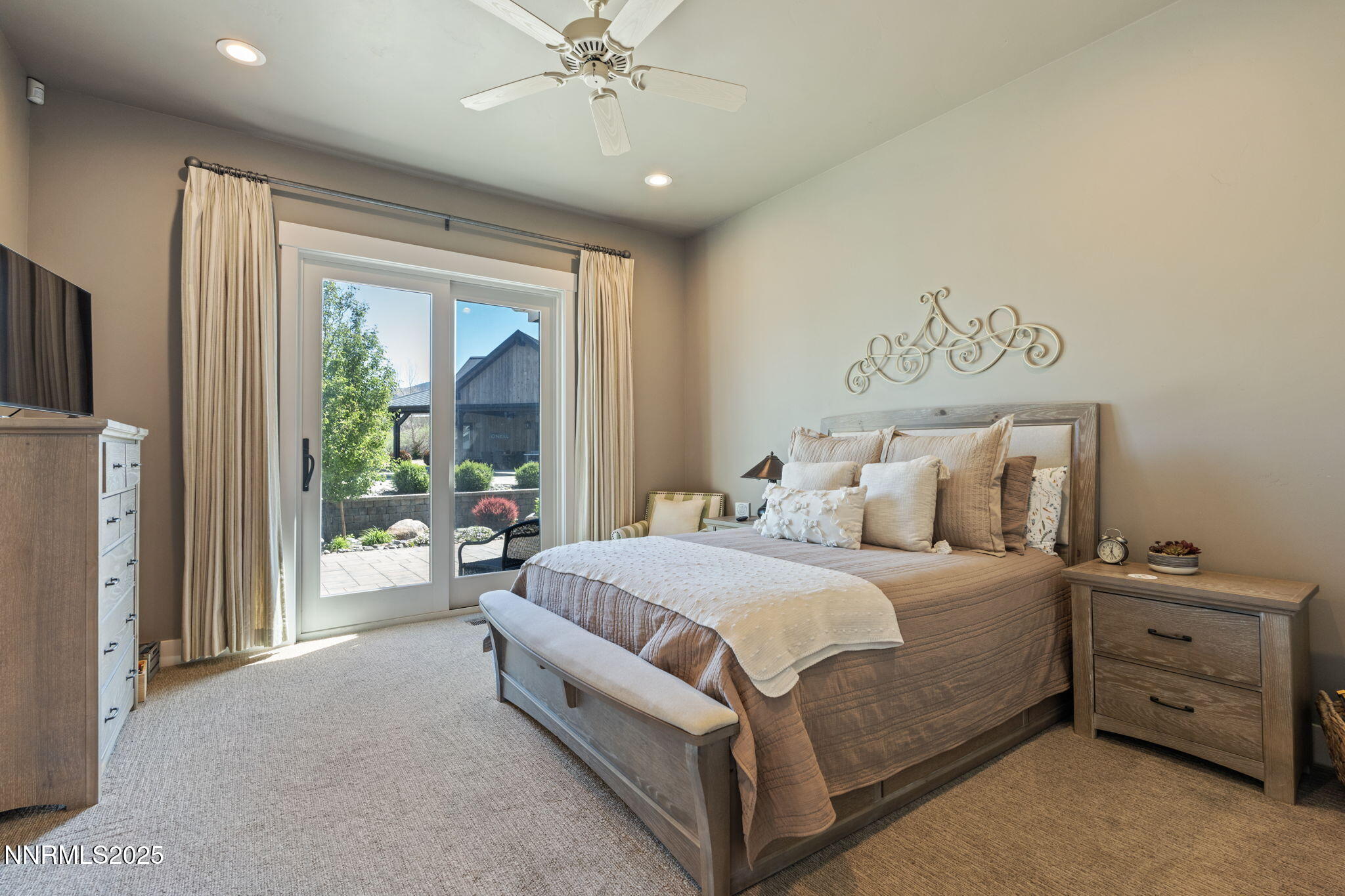 1020 North Cantlon Lane Reno, NV 89521 - Photo 20 of 28 a spacious bedroom with a bed and a chandelier