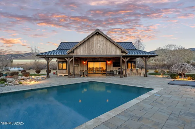 a living room with furniture a table and kitchen view