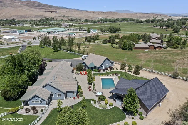 an aerial view of a house with garden space and lake view