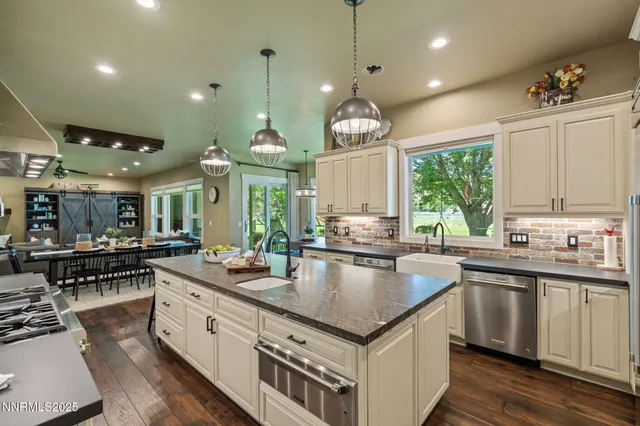 a large kitchen with kitchen island a large counter space a sink appliances and a counter top space