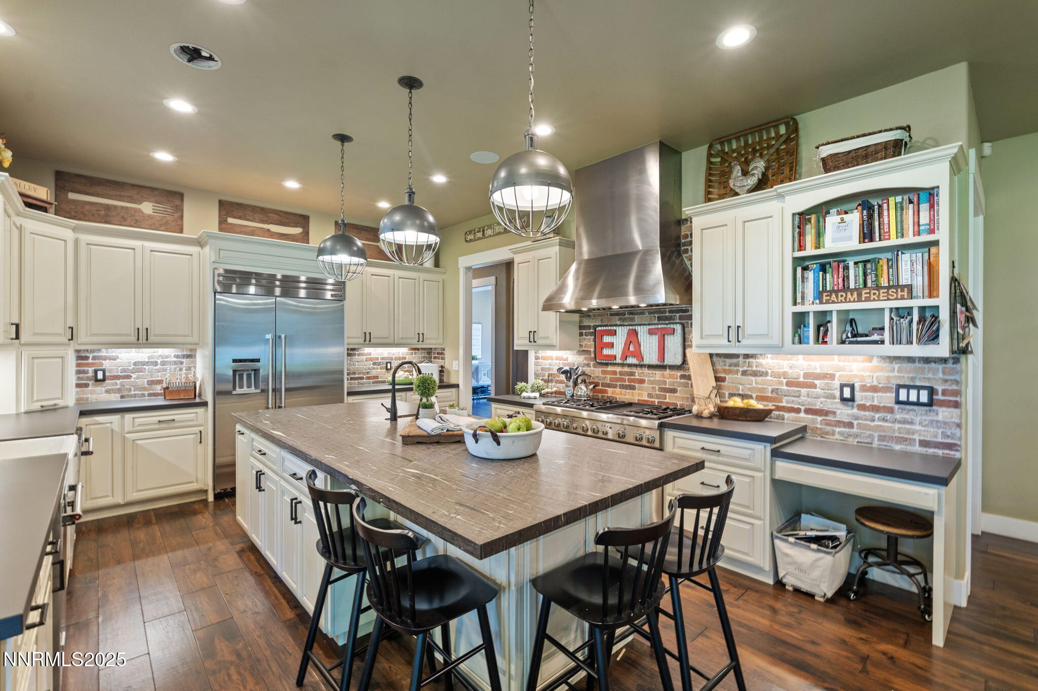 1020 North Cantlon Lane Reno, NV 89521 - Photo 8 of 28 a kitchen with a dining table chairs stainless steel appliances and cabinets