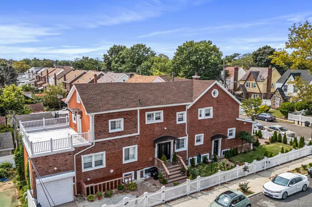 a aerial view of a brick house next to a yard