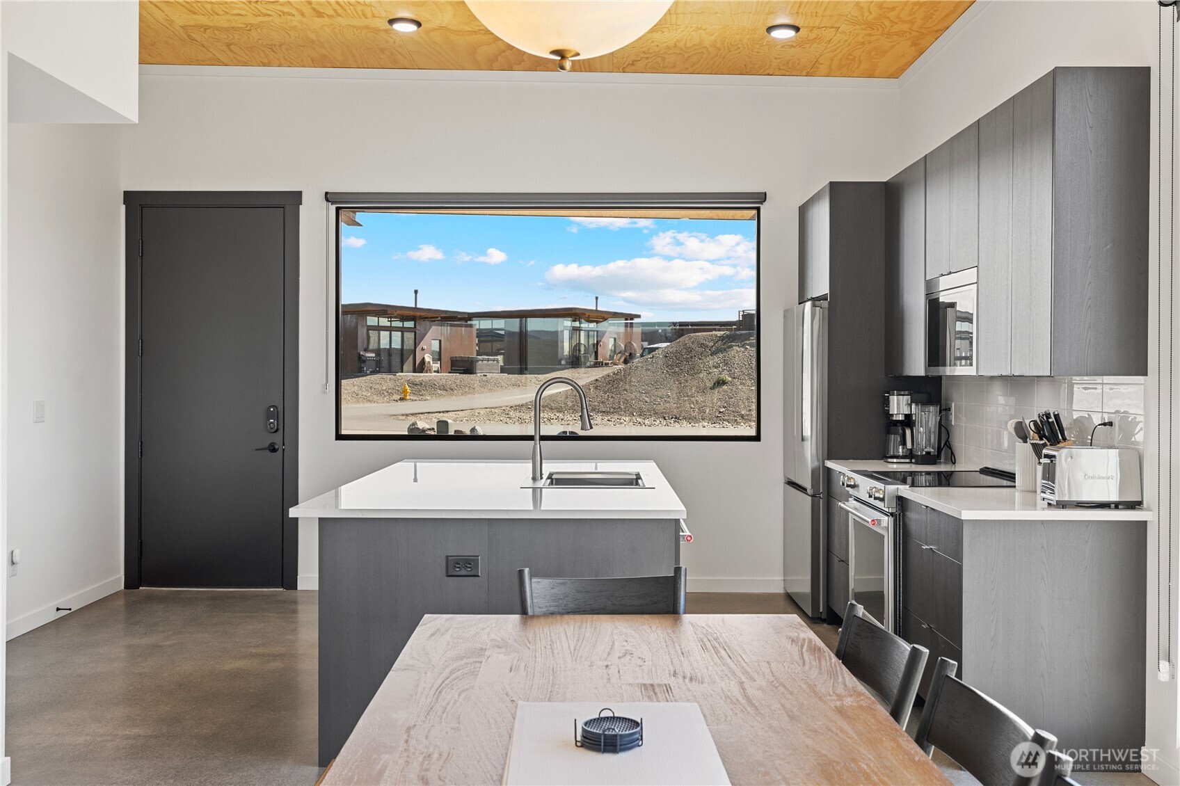 202 Rattlesnake Pt Road Northwest Quincy, WA 98848 - Photo 12 of 37 a kitchen with a sink and a refrigerator