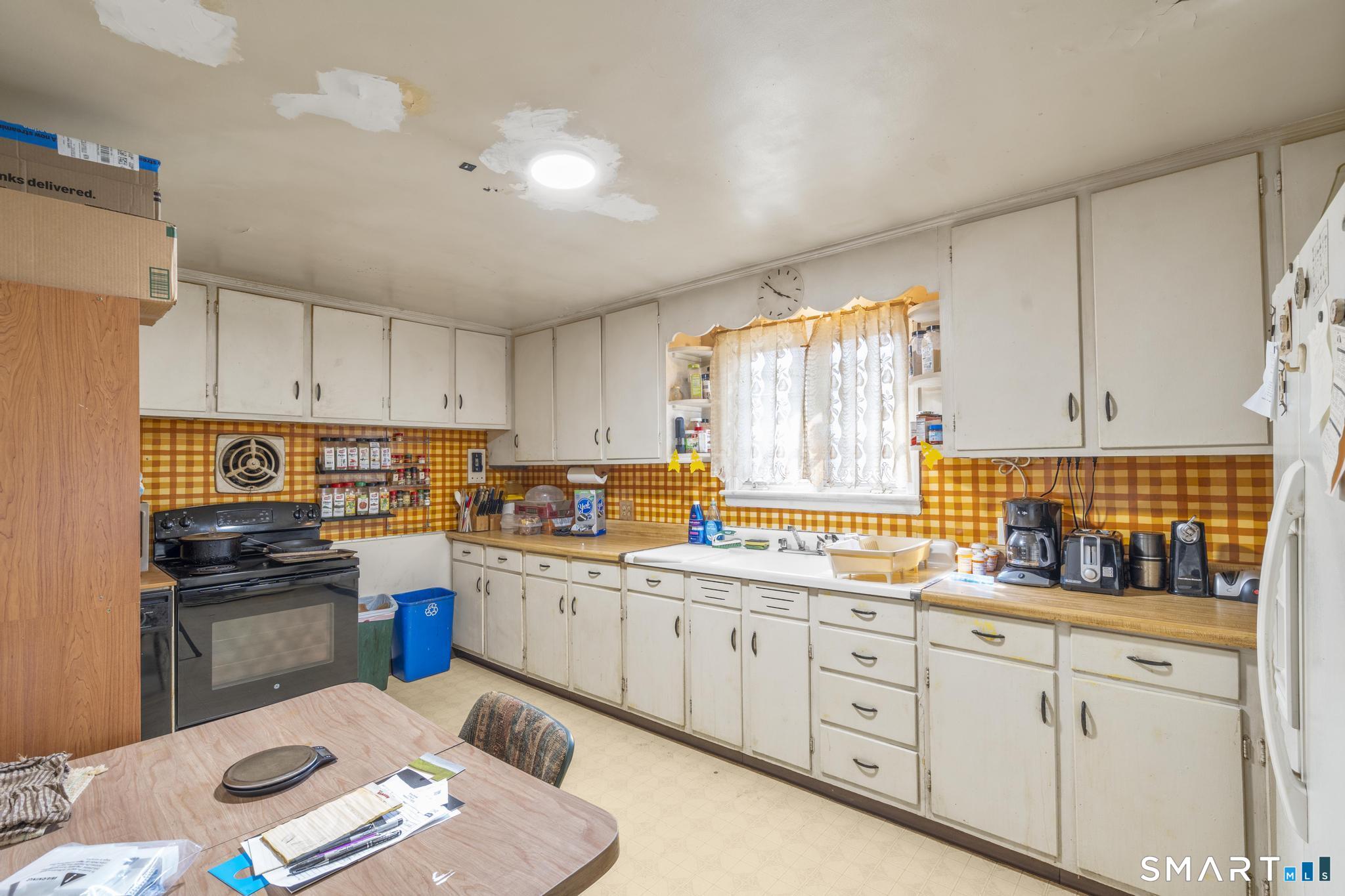 30 Parklawn Drive Waterbury, CT 06708 - Photo 7 of 22 a kitchen with cabinets a sink and appliances