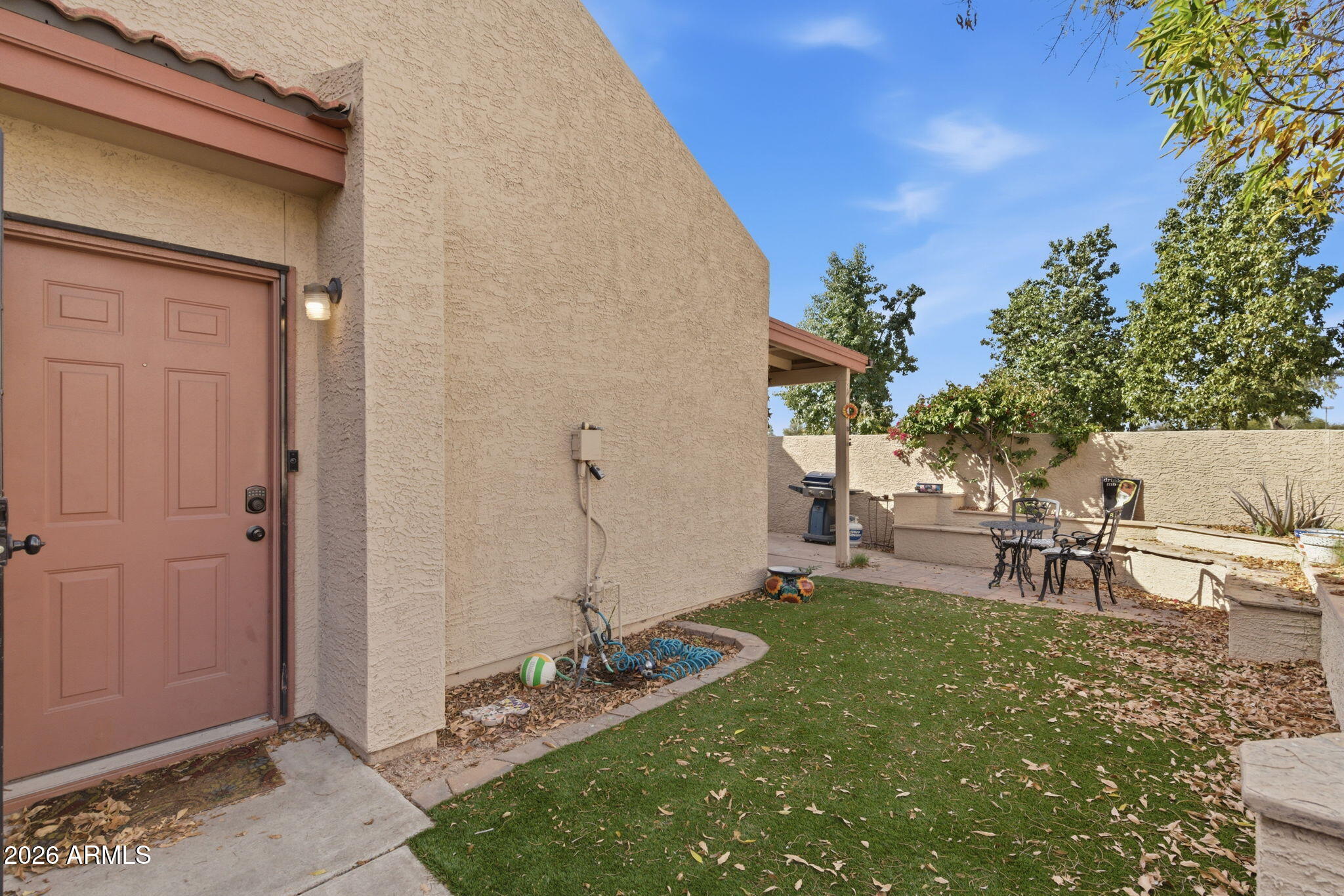 4218 West Boca Raton Road Phoenix, AZ 85053 - Photo 2 of 27 a view of backyard of a house with table and chairs