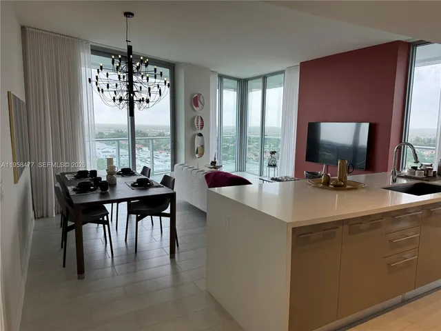 a room with a table chairs and a chandelier