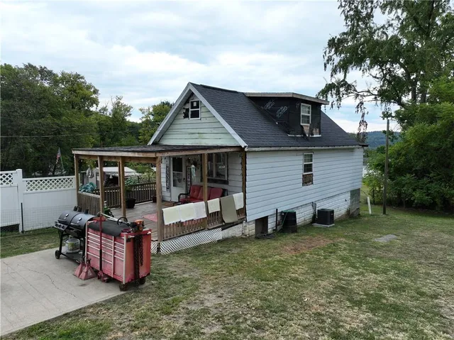 a view of a house with backyard sitting area and garden