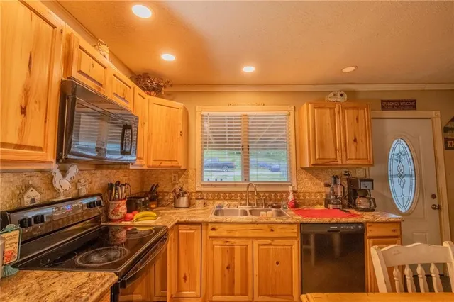 a kitchen that has a sink and a stove