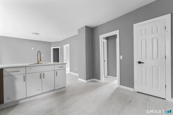 a spacious bathroom with 2 sink and a mirror