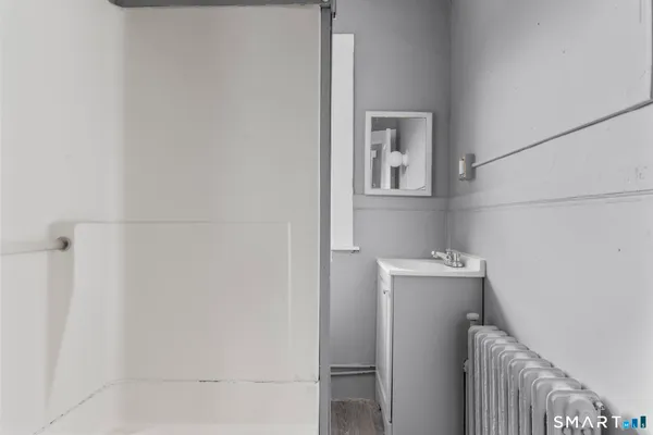 a bathroom with a bathtub and shower