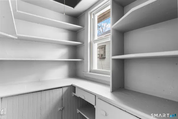 a kitchen with a white cabinets and a window