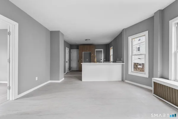 a view of a room with a window and kitchen view