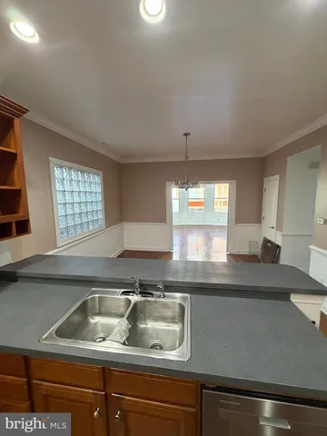 a kitchen with a sink cabinets and window