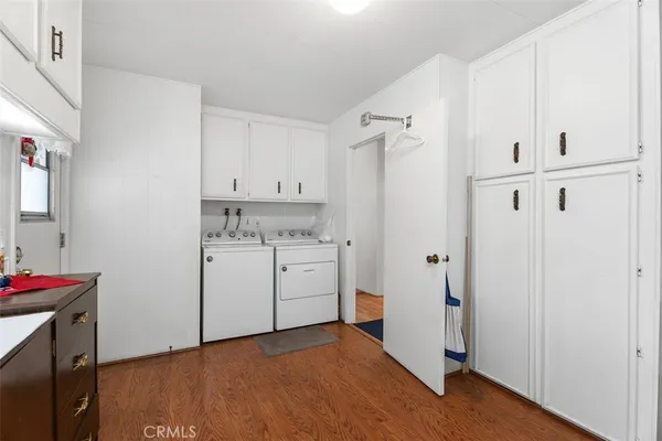 a kitchen with cabinets appliances and a dining table