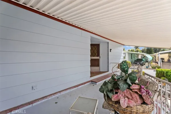 a view of backyard with outdoor seating and plants