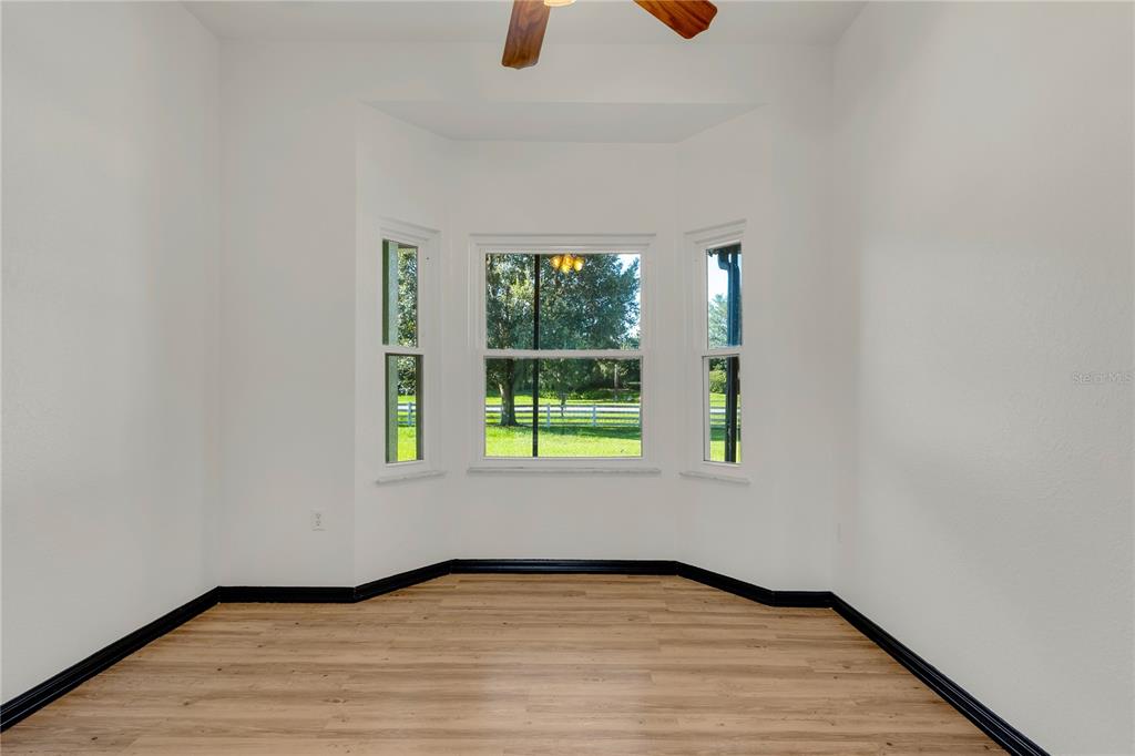 4831 Rummell Road St. Cloud, FL 34771 - Photo 11 of 37 an empty room with window and wooden floor