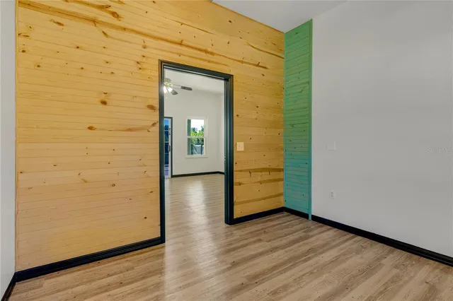 an empty room with wooden floor and closet