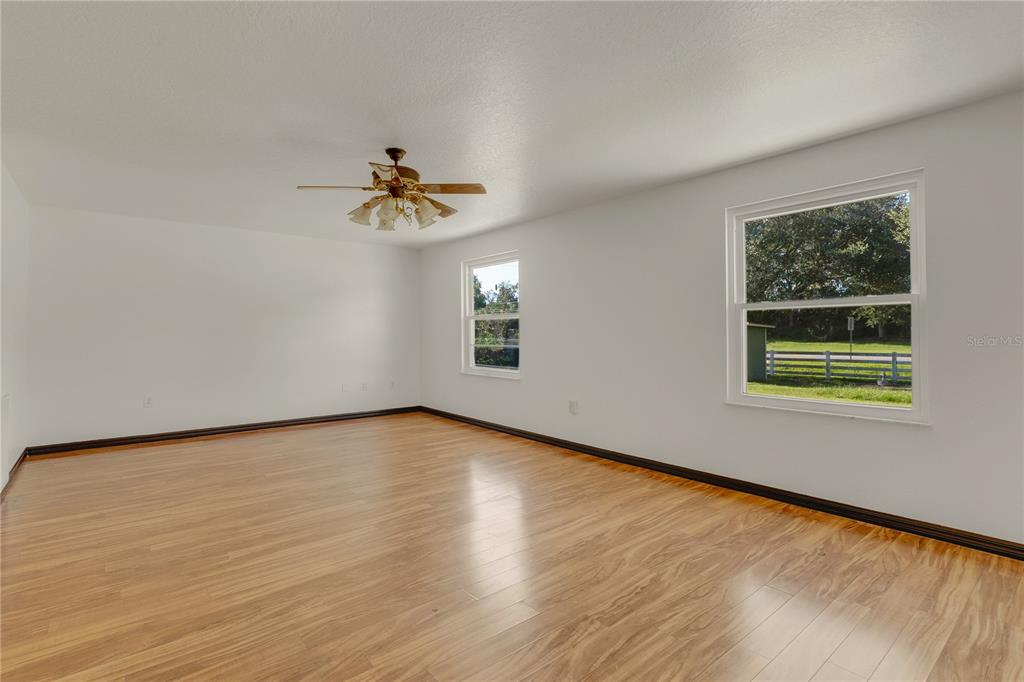 4831 Rummell Road St. Cloud, FL 34771 - Photo 16 of 37 wooden floor in an empty room with a window