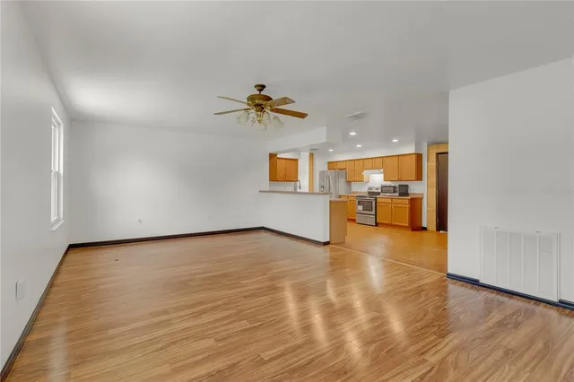 wooden floor in an empty room with a window