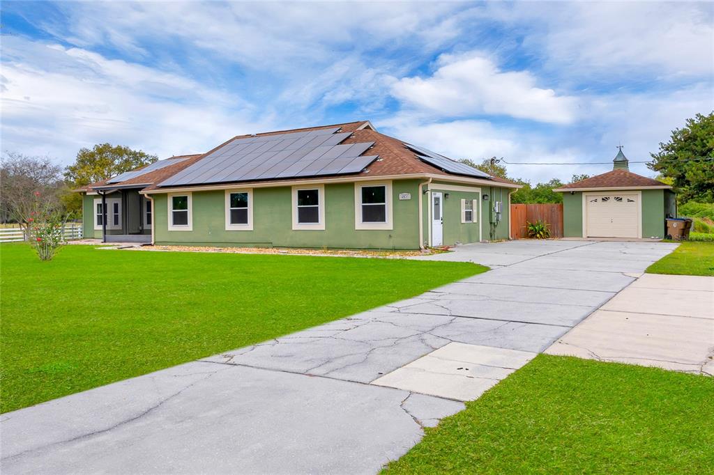 4831 Rummell Road St. Cloud, FL 34771 - Photo 2 of 37 a front view of a house with a garden and yard