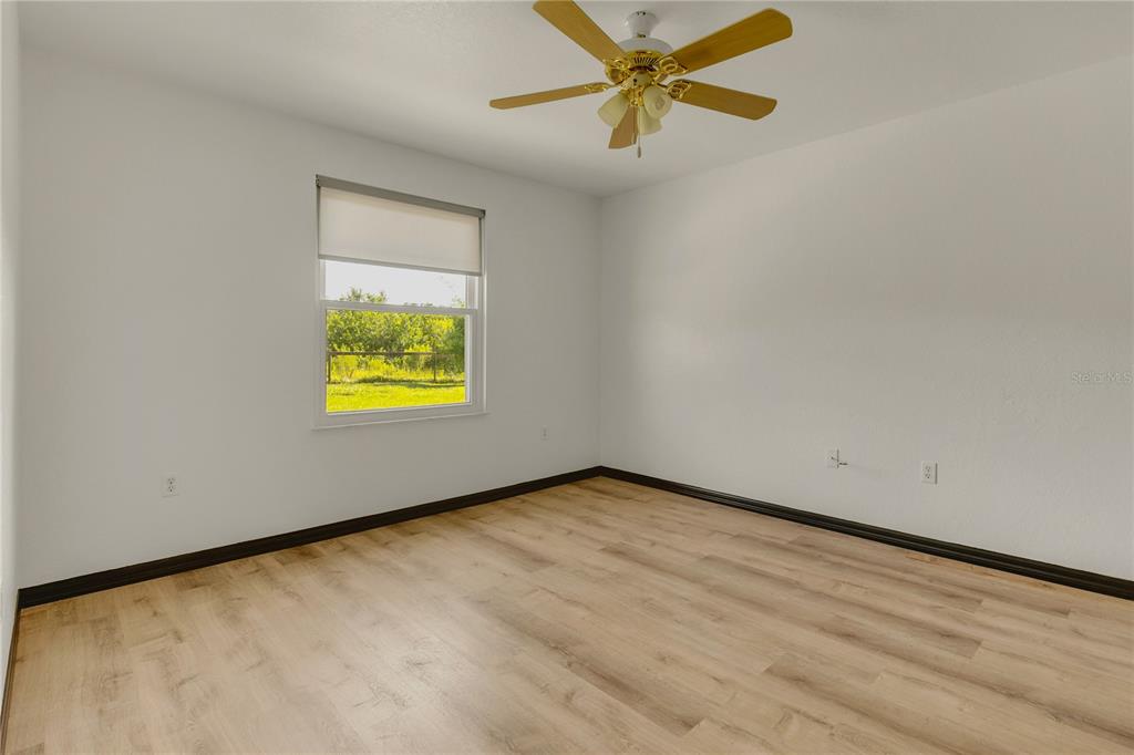 4831 Rummell Road St. Cloud, FL 34771 - Photo 22 of 37 an empty room with a window and a ceiling fan