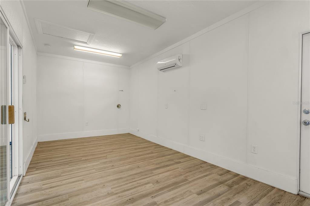 4831 Rummell Road St. Cloud, FL 34771 - Photo 26 of 37 a view of an empty room with wooden floor