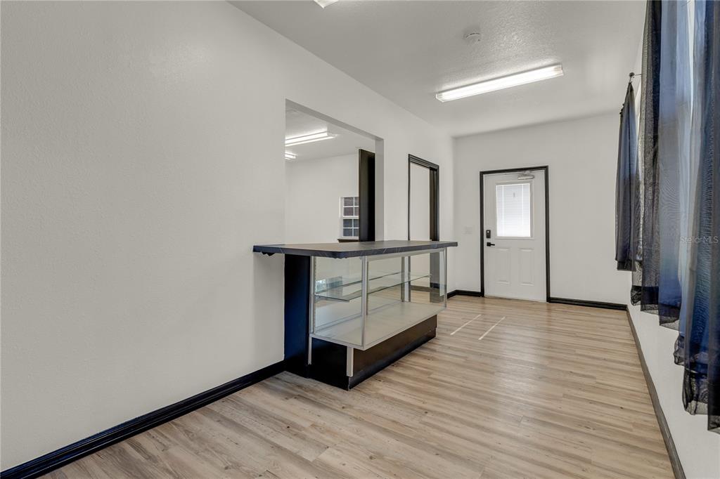 4831 Rummell Road St. Cloud, FL 34771 - Photo 29 of 37 a view of an empty room with wooden floor and a window