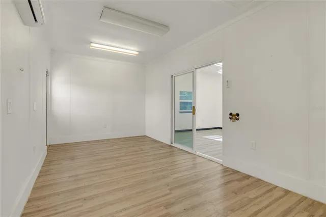 a view of an empty room with wooden floor
