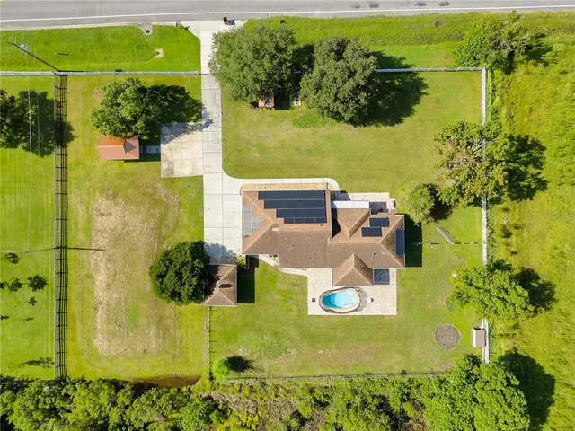 an aerial view of a house with a swimming pool