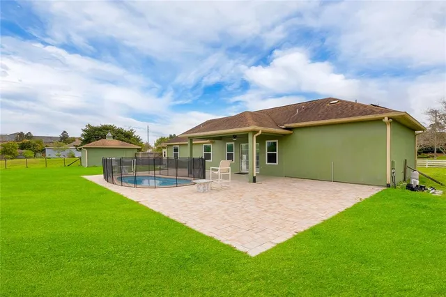 a view of house with backyard