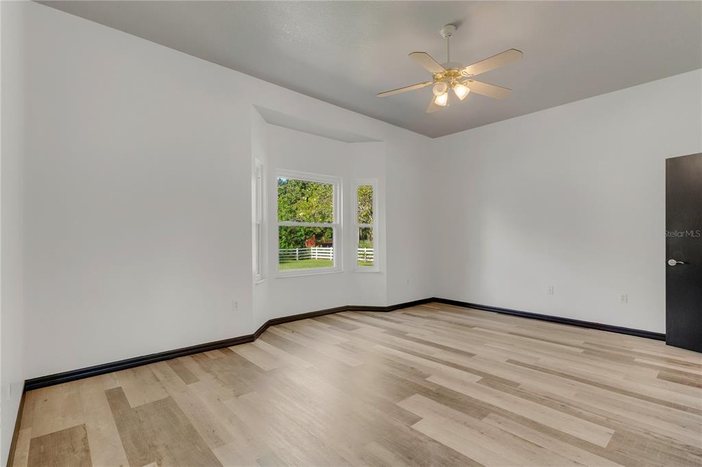 4831 Rummell Road St. Cloud, FL 34771 - Photo 6 of 37 an empty room with a window and a ceiling fan