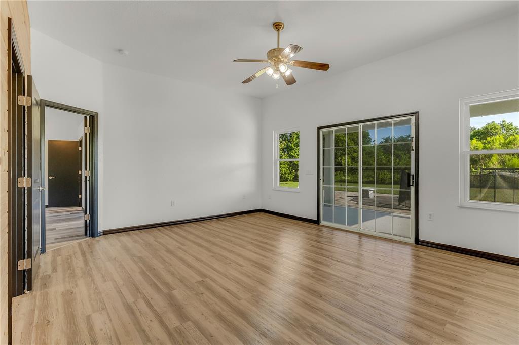 4831 Rummell Road St. Cloud, FL 34771 - Photo 8 of 37 a view of an empty room with wooden floor and a window