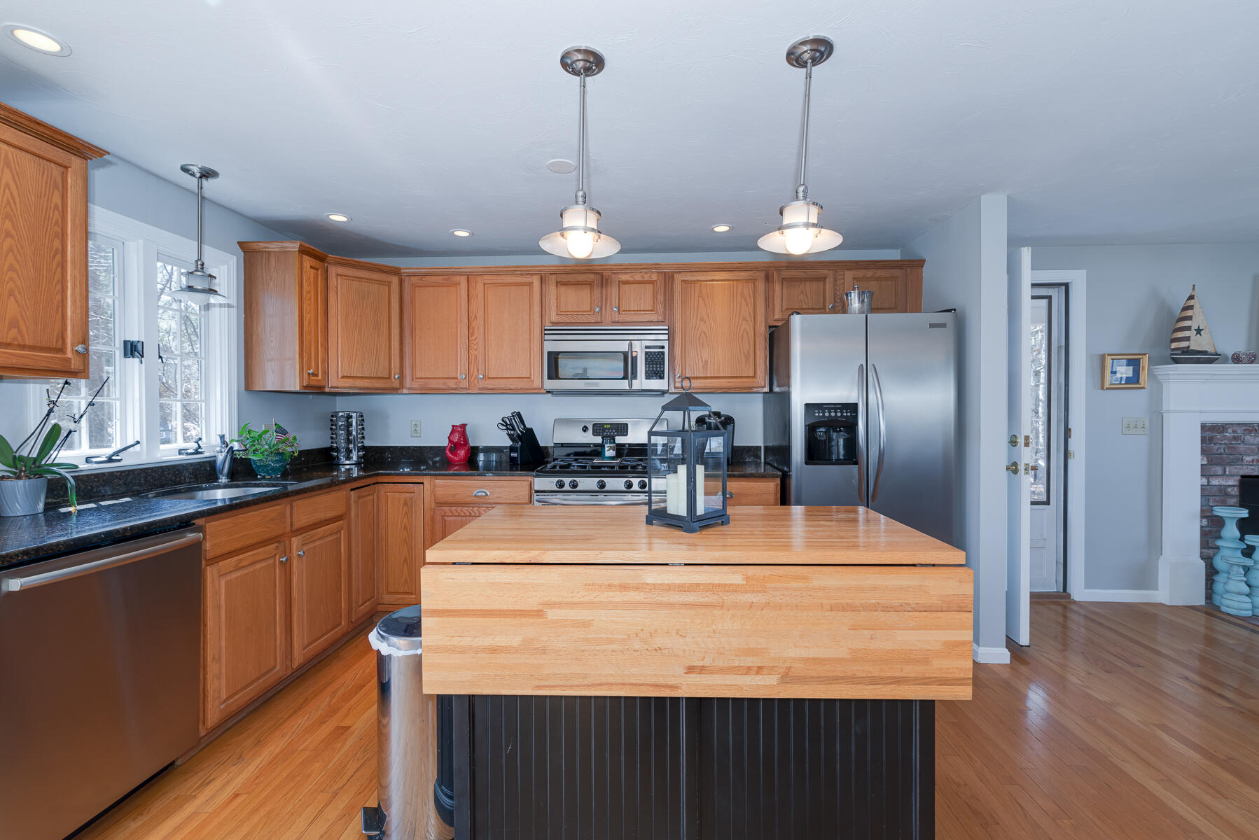 1 Country Farm Road Forestdale, MA 02644 - Photo 14 of 54 a kitchen with stainless steel appliances kitchen island granite countertop a sink a refrigerator and a wooden cabinets