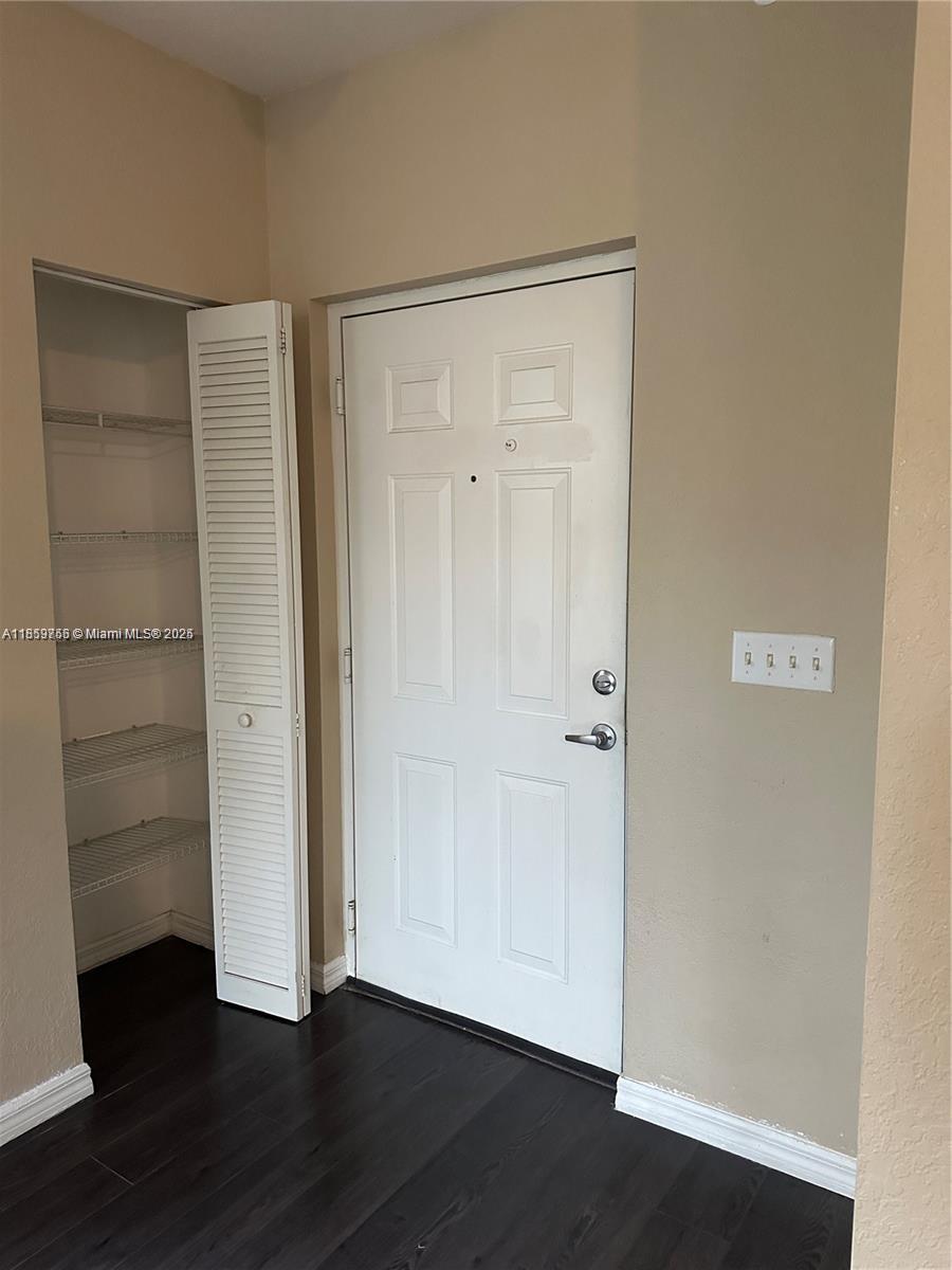 6790 West Sample Road, Unit 6790 Coral Springs, FL 33067 - Photo 11 of 26 a view of an empty room with wooden floor