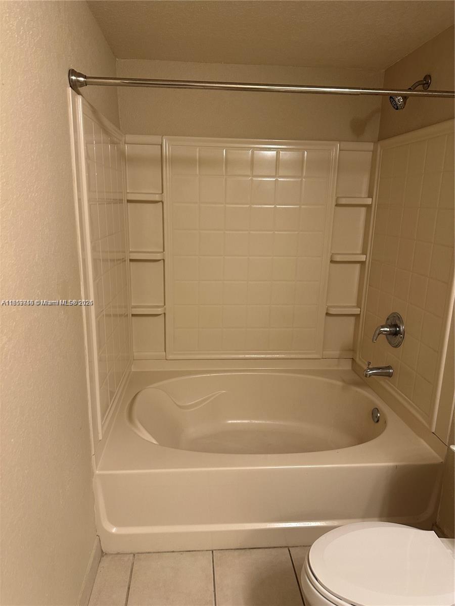 6790 West Sample Road, Unit 6790 Coral Springs, FL 33067 - Photo 19 of 26 a bathroom with a shower and a toilet