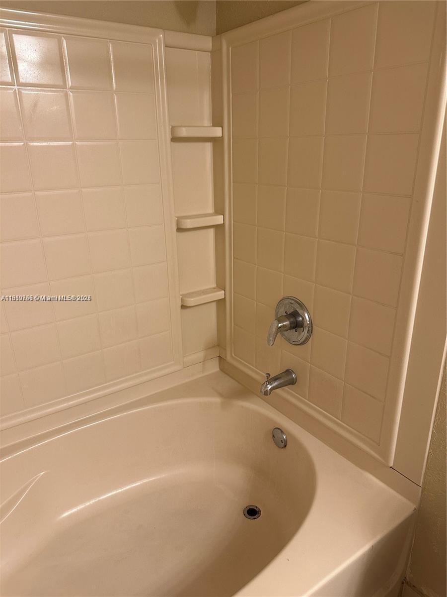 6790 West Sample Road, Unit 6790 Coral Springs, FL 33067 - Photo 20 of 26 a bathroom with a tub