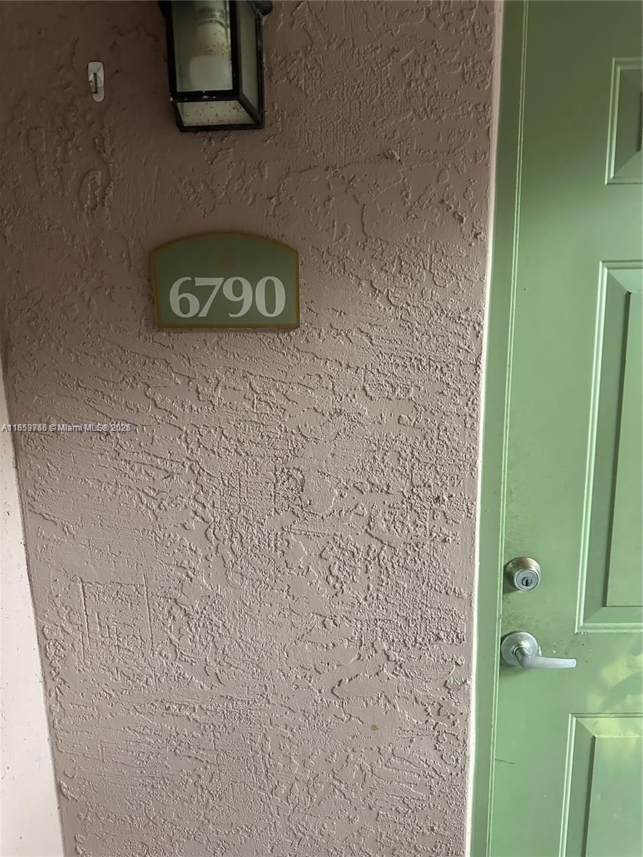 6790 West Sample Road, Unit 6790 Coral Springs, FL 33067 - Photo 25 of 26 a bathroom with a shower and a sink
