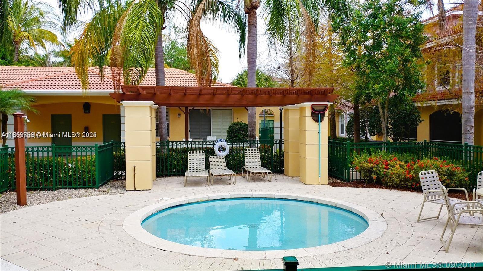 6790 West Sample Road, Unit 6790 Coral Springs, FL 33067 - Photo 3 of 26 a view of outdoor space yard swimming pool and patio